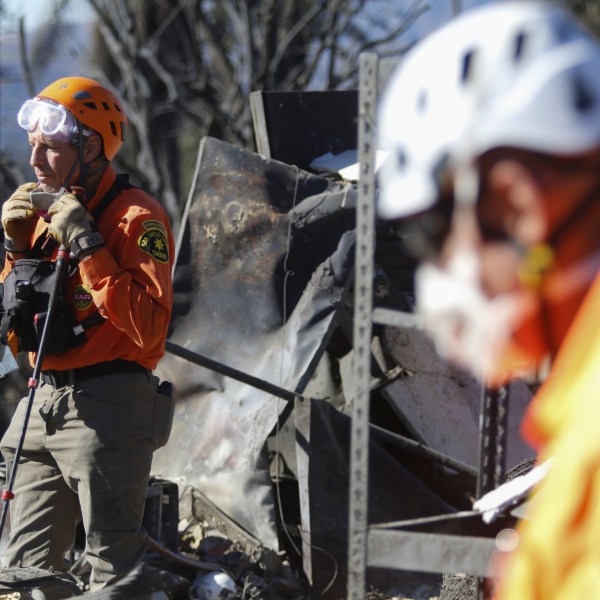 Search and rescue workers dig through the rubble left behind by the Eaton Fire, in Altadena, Calif., Tuesday, Jan. 14, 2025. (AP Photo/Ty O'Neil)