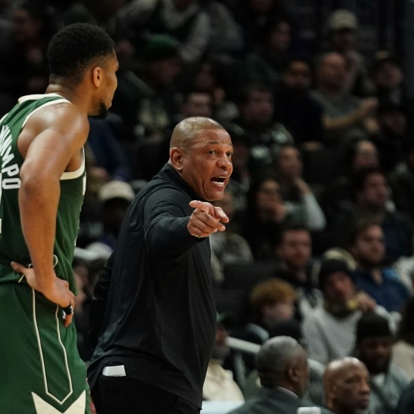 Milwaukee Bucks head coach Doc Rivers, right, gestures as he talks with Giannis Antetokounmpo during the first half of an NBA basketball game against the Sacramento Kings, Tuesday, Jan. 14, 2025, in Milwaukee. (AP Photo/Aaron Gash)