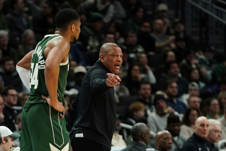 Milwaukee Bucks head coach Doc Rivers, right, gestures as he talks with Giannis Antetokounmpo during the first half of an NBA basketball game against the Sacramento Kings, Tuesday, Jan. 14, 2025, in Milwaukee. (AP Photo/Aaron Gash)