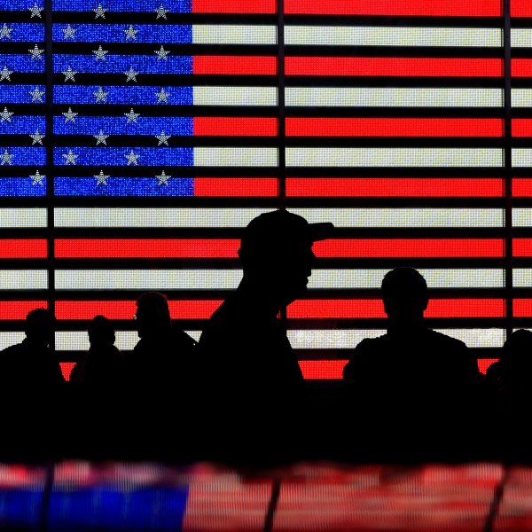 FILE - People stand in Times Square in New York, Aug. 9, 2024. (AP Photo/Pamela Smith, File)