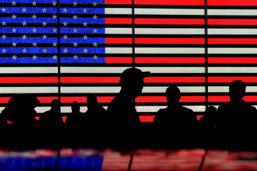 FILE - People stand in Times Square in New York, Aug. 9, 2024. (AP Photo/Pamela Smith, File)