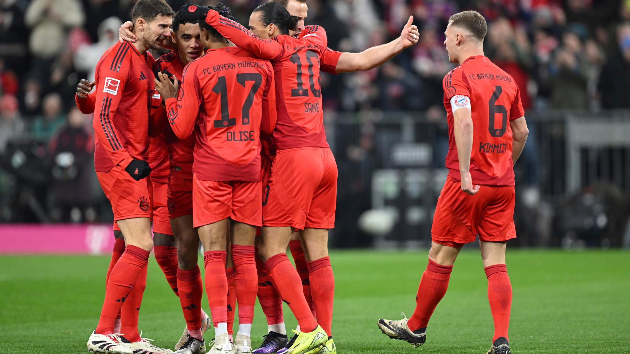 Munich players celebrate Jamal Musiala's goal during the Bundesliga soccer match between Bayern Munich and RB Leipzig at the Allianz Arena, Munich, Germany, Friday Dec. 20, 2024. (Sven Hoppe/dpa via AP)