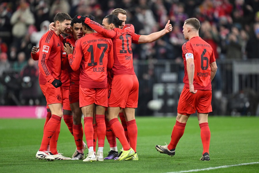 Munich players celebrate Jamal Musiala's goal during the Bundesliga soccer match between Bayern Munich and RB Leipzig at the Allianz Arena, Munich, Germany, Friday Dec. 20, 2024. (Sven Hoppe/dpa via AP)