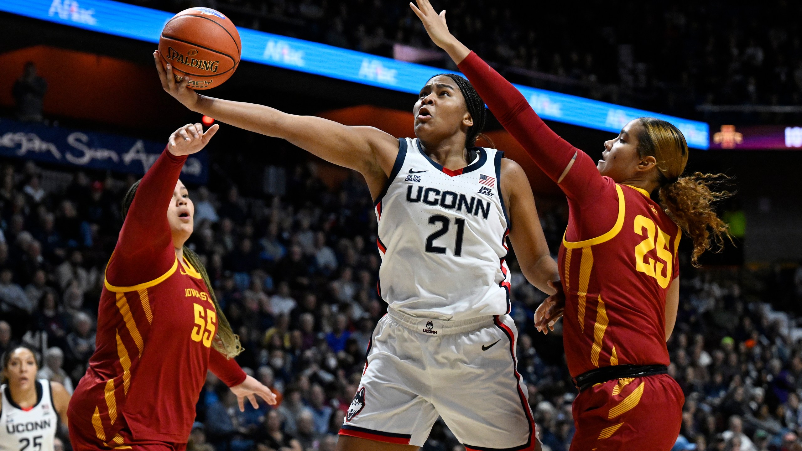 UConn forward Sarah Strong (21) shoots between Iowa State center Audi Crooks (55) and Iowa State guard Sydney Harris (25) in the first half of an NCAA college basketball game, Tuesday, Dec. 17, 2024, in Uncasville, Conn. (AP Photo/Jessica Hill)