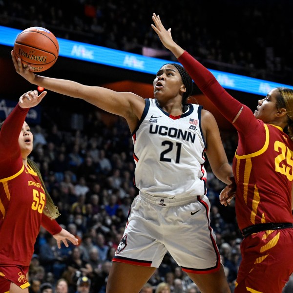 UConn forward Sarah Strong (21) shoots between Iowa State center Audi Crooks (55) and Iowa State guard Sydney Harris (25) in the first half of an NCAA college basketball game, Tuesday, Dec. 17, 2024, in Uncasville, Conn. (AP Photo/Jessica Hill)