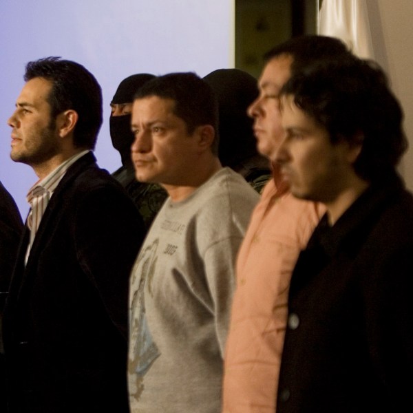 FILE - Military officers guard alleged drug trafficker Vicente Zambada, third left front, and five unidentified men who were presented to the press as Zambada's alleged bodyguards in Mexico City, March 19, 2009. Vicente Zambada is the son of Mexican drug lord Ismael Zambada, head of the Sinaloa cartel. (AP Photo/Eduardo Verdugo, File)