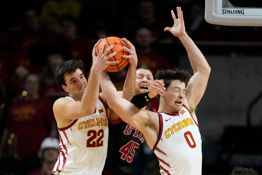 Iowa State forward Milan Momcilovic (22) and guard Nate Heise (0) fight for a rebound with Utah guard Mason Madsen (45) during the second half of an NCAA college basketball game Tuesday, Jan. 7, 2025, in Ames, Iowa. (AP Photo/Charlie Neibergall)