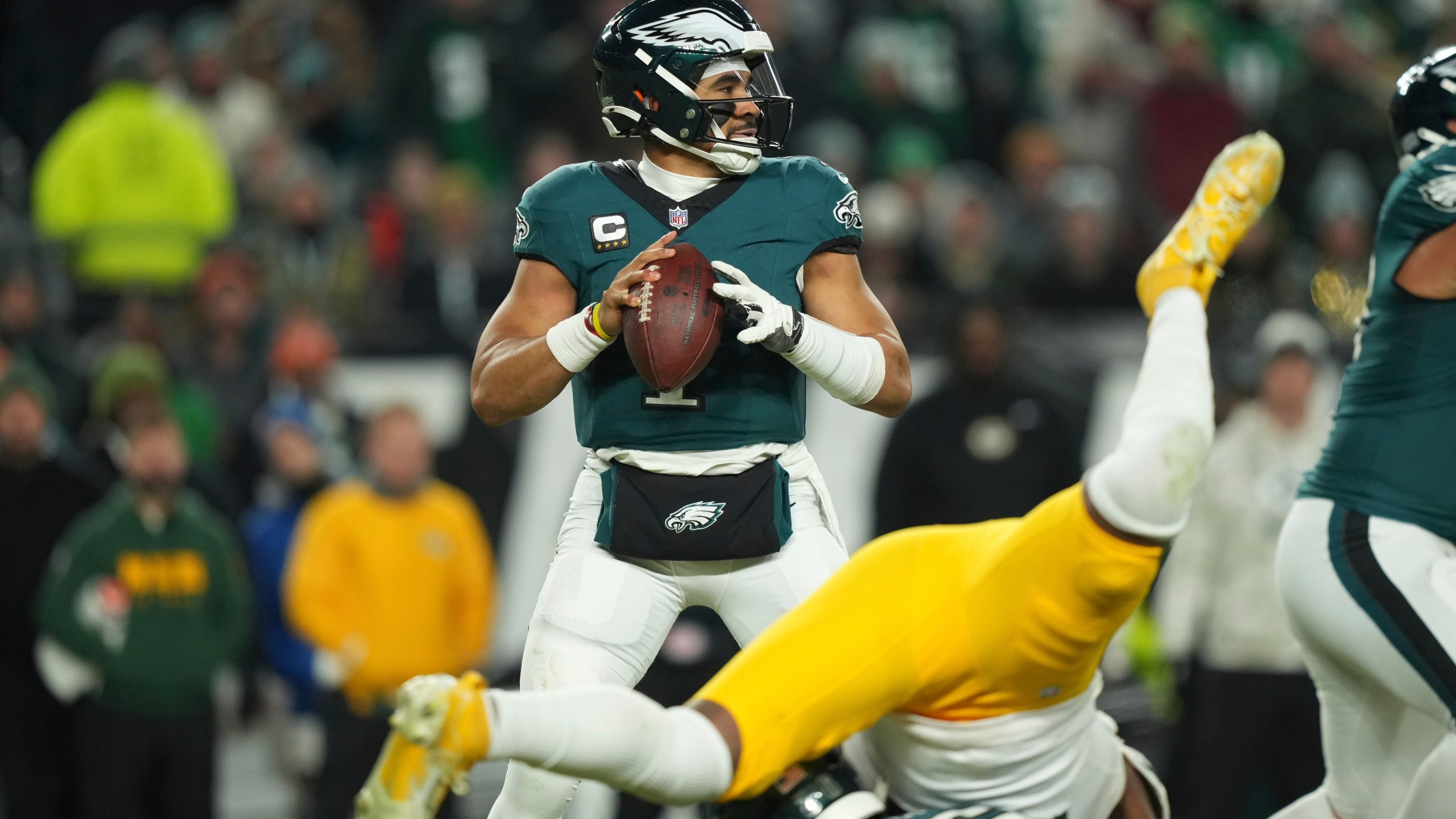 Philadelphia Eagles quarterback Jalen Hurts (1) looks to pass during the second half of an NFL wild-card playoff football game against the Green Bay Packers on Sunday, Jan. 12, 2025, in Philadelphia. (AP Photo/Matt Slocum)