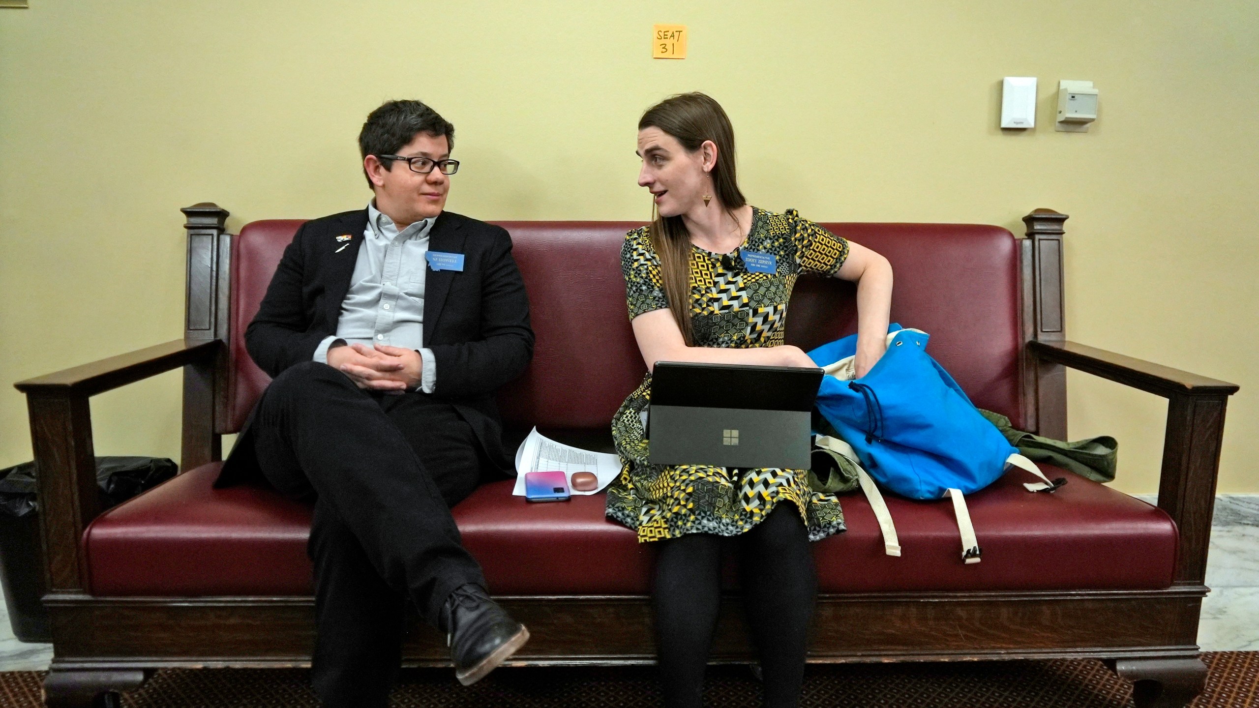 FILE - State Rep. Zooey Zephyr, right, speaks with colleague Rep. SJ Howell after House Speaker Matt Regier told her she could not work from the hallway just outside the main chamber of the House, April 27, 2023 in Helena, Mont. (AP Photo/Brittany Peterson, File)