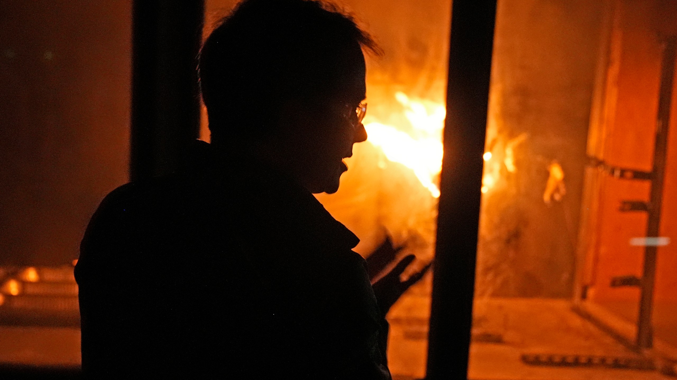 James Urban, assistant professor in the department of Fire Protection Engineering at Worcester Polytechnic Institute, watches a fire burn in a wind tunnel, Wednesday, Jan. 15, 2025, in Worcester, Mass. (AP Photo/Robert F. Bukaty)