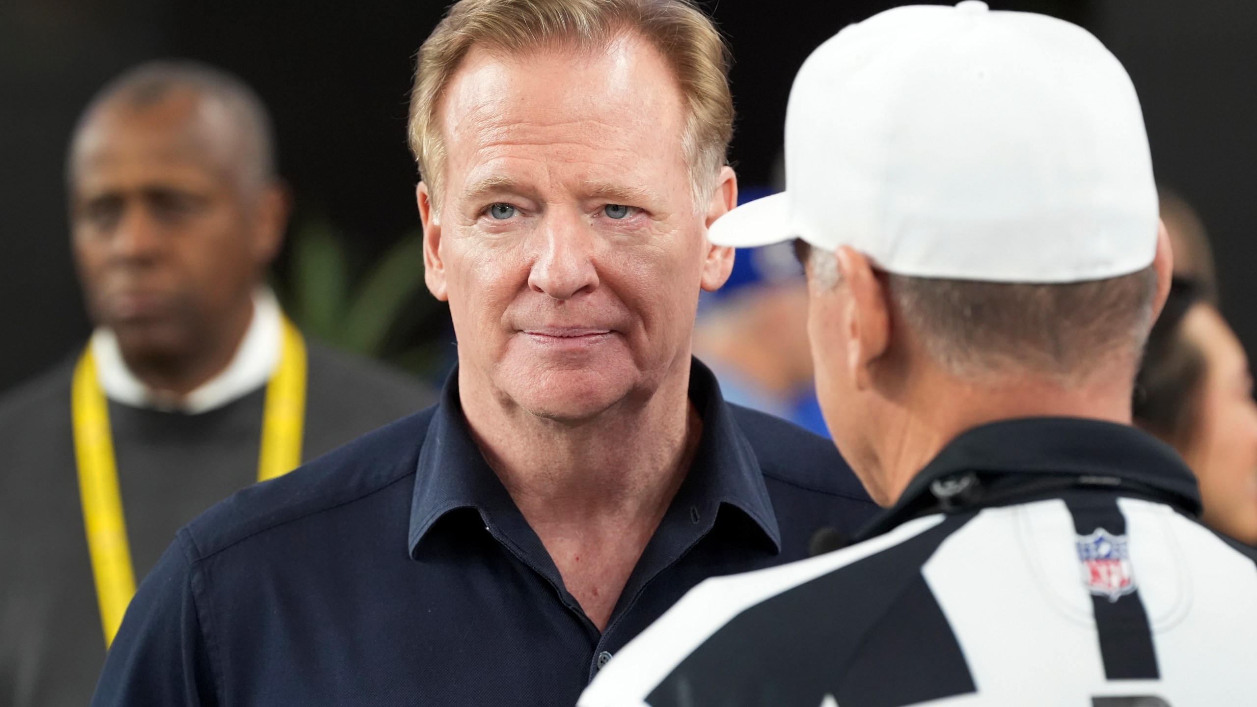 NFL Commissioner Roger Goodell, left, talks with Referee John Hussey before an NFL wild card playoff football game between the Los Angeles Rams and Minnesota Vikings, Monday, Jan. 13, 2025, in Glendale, Ariz. (AP Photo/Ross D. Franklin)