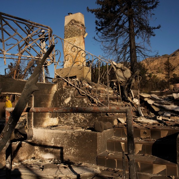 A firefighter inspects homes destroyed by the Eaton Fire in in Altadena, Calif., is seen Wednesday, Jan 15, 2025. (AP Photo/John Locher)