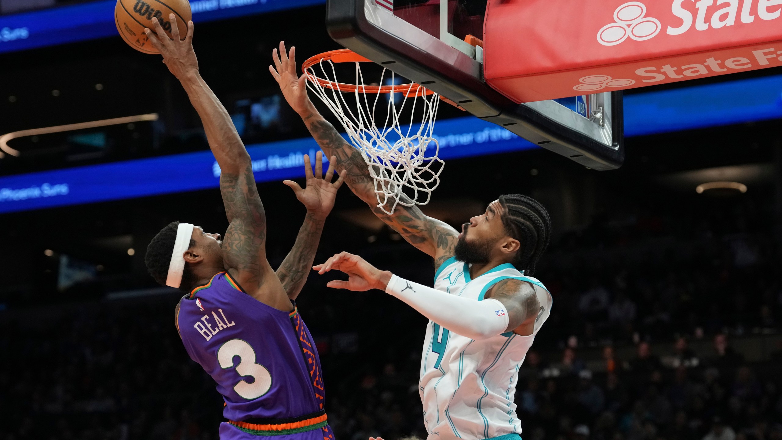 Phoenix Suns guard Bradley Beal (3) goes up to shoot over Charlotte Hornets center Nick Richards (4) during the second half of an NBA basketball game Sunday, Jan. 12, 2025, in Phoenix. (AP Photo/Ross D. Franklin)