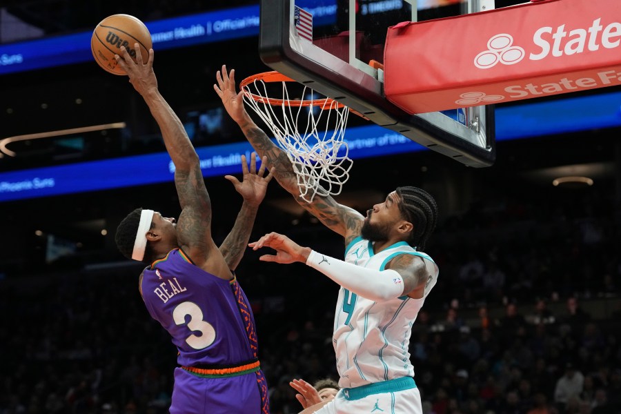 Phoenix Suns guard Bradley Beal (3) goes up to shoot over Charlotte Hornets center Nick Richards (4) during the second half of an NBA basketball game Sunday, Jan. 12, 2025, in Phoenix. (AP Photo/Ross D. Franklin)