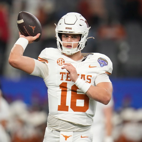 Texas quarterback Arch Manning warms up before the Cotton Bowl College Football Playoff semifinal game against Ohio State, Friday, Jan. 10, 2025, in Arlington, Texas. (AP Photo/Julio Cortez)