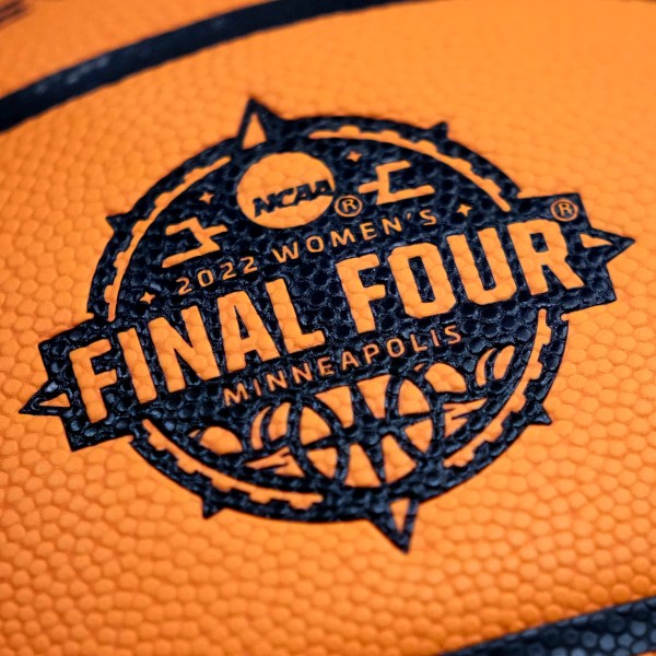 FILE - A logo is seen on a basketball during a practice session for a college basketball game in the final round of the Women's Final Four NCAA tournament Saturday, April 2, 2022, in Minneapolis. (AP Photo/Charlie Neibergall, File)