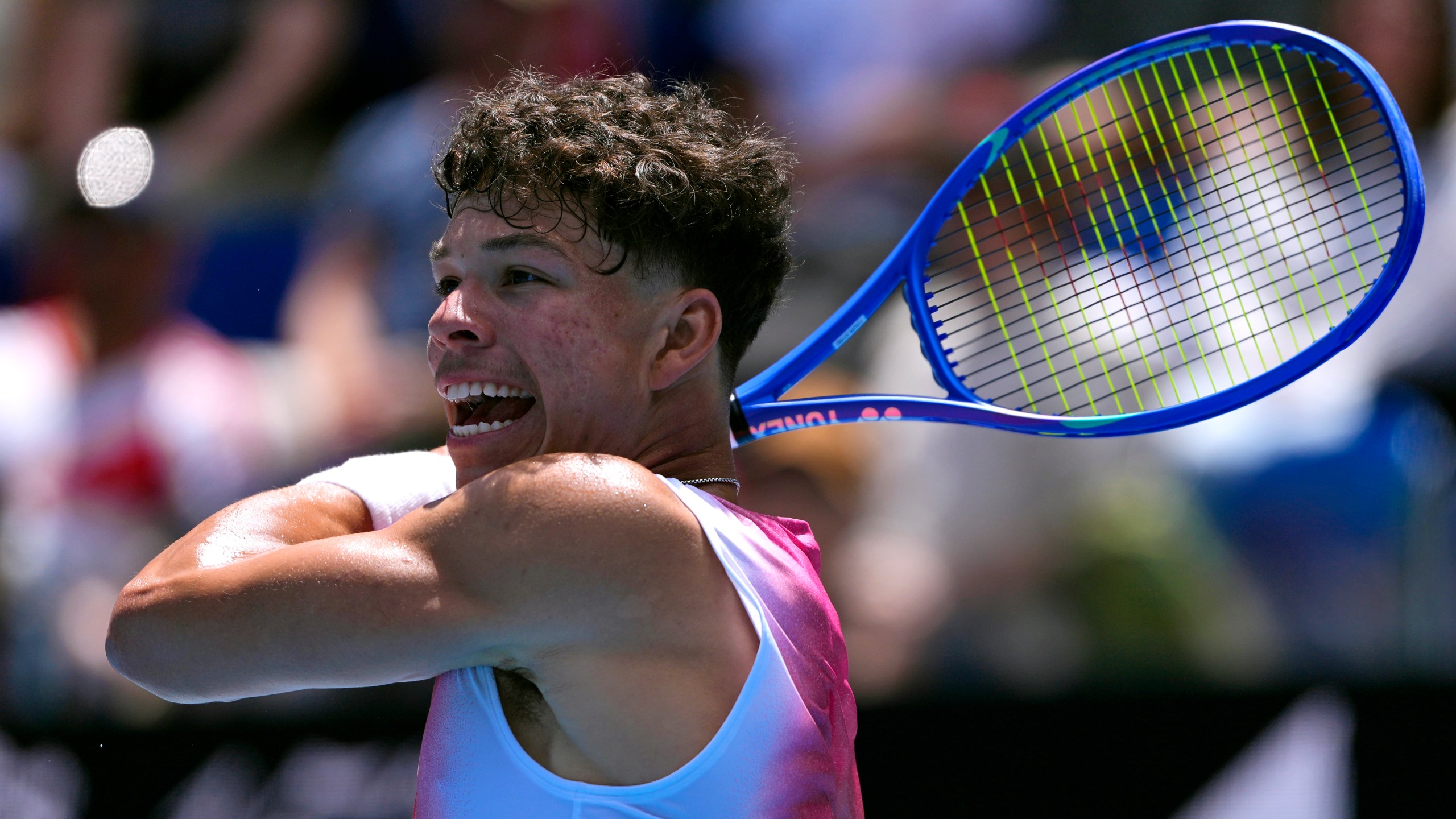 Ben Shelton of the U.S. plays a forehand return to Pablo Carreno Busta of Spain during their second round match at the Australian Open tennis championship in Melbourne, Australia, Thursday, Jan. 16, 2025. (AP Photo/Vincent Thian)