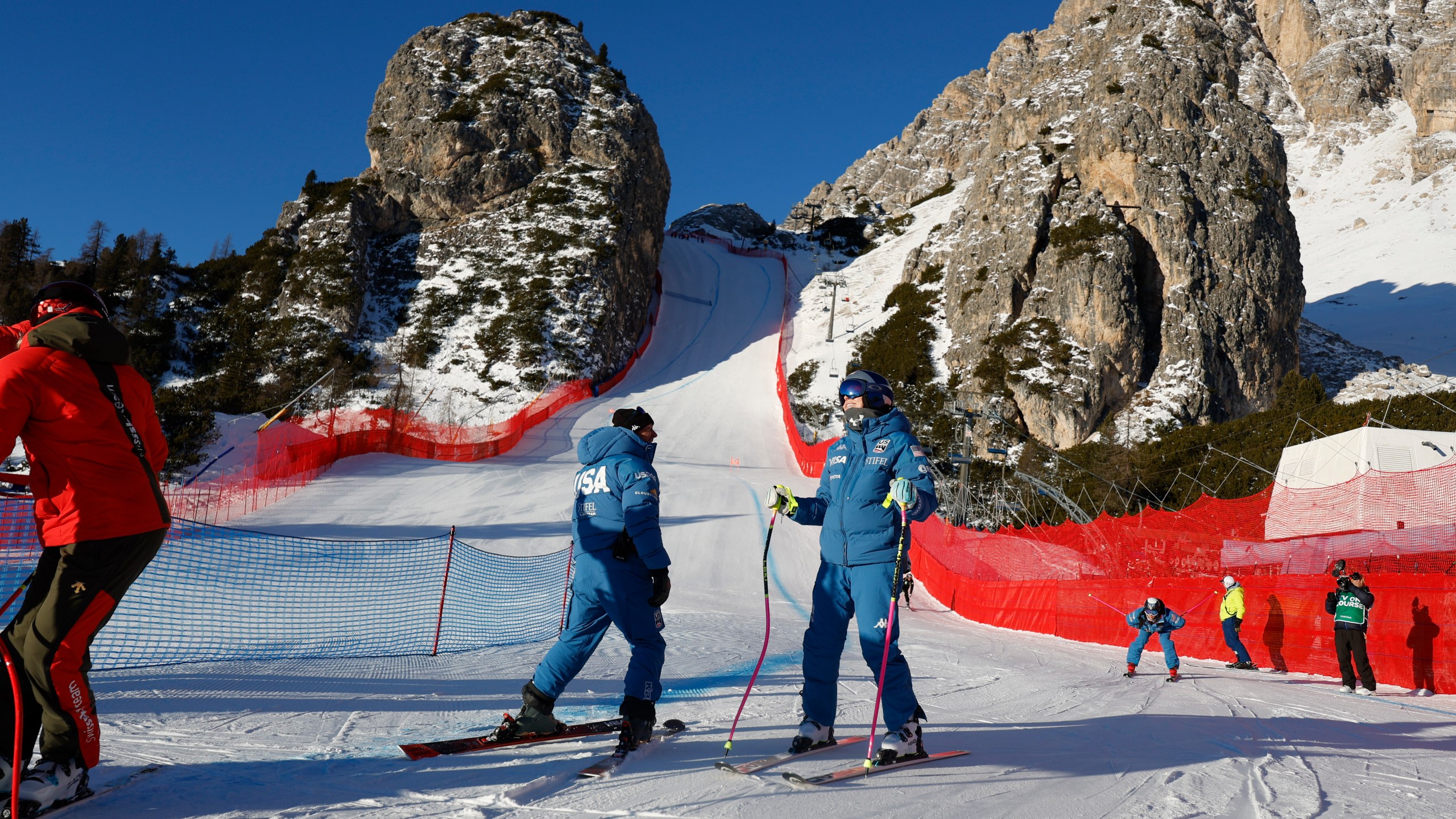 United States' Lindsey Vonn, center right, inspects the course ahead of an alpine ski, women's World Cup downhill training, in Cortina d'Ampezzo, Italy, Thursday, Jan. 16, 2025. (AP Photo/Alessandro Trovati)