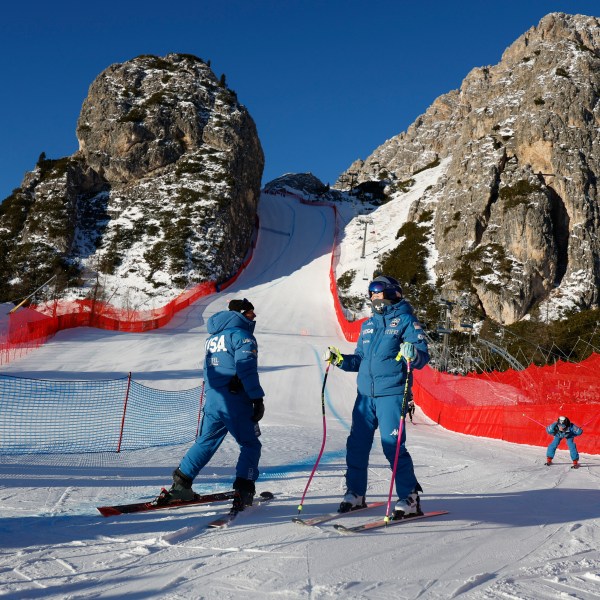 United States' Lindsey Vonn, center right, inspects the course ahead of an alpine ski, women's World Cup downhill training, in Cortina d'Ampezzo, Italy, Thursday, Jan. 16, 2025. (AP Photo/Alessandro Trovati)