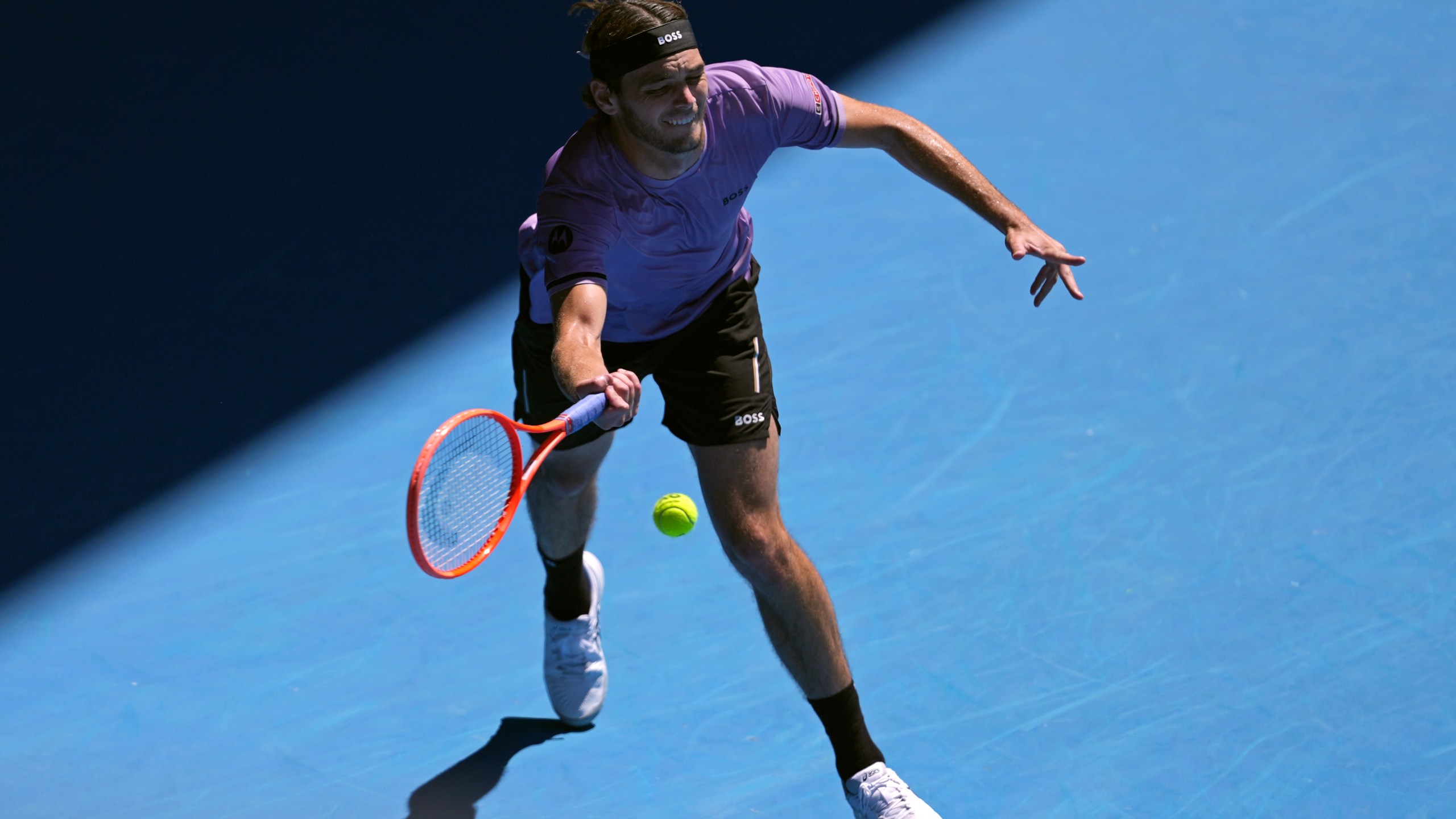 Taylor Fritz of the U.S. plays a forehand return to Cristian Garin of Chile during their second round match at the Australian Open tennis championship in Melbourne, Australia, Thursday, Jan. 16, 2025. (AP Photo/Ng Han Guan)