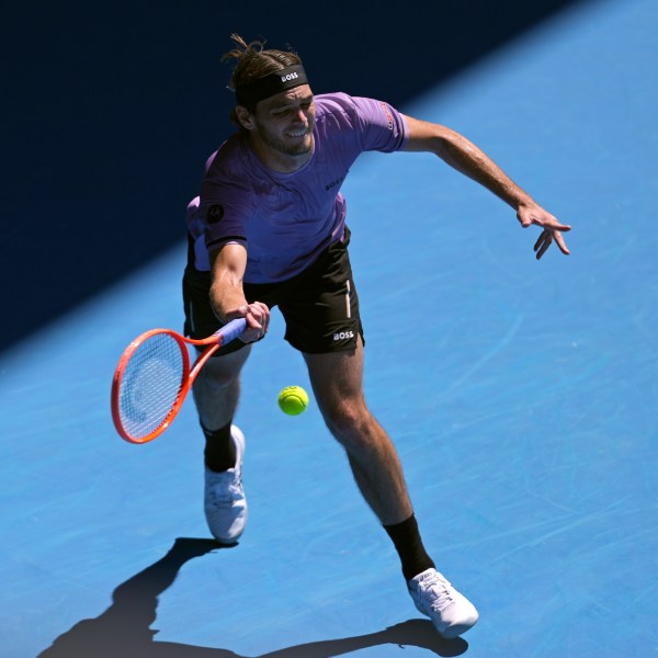 Taylor Fritz of the U.S. plays a forehand return to Cristian Garin of Chile during their second round match at the Australian Open tennis championship in Melbourne, Australia, Thursday, Jan. 16, 2025. (AP Photo/Ng Han Guan)