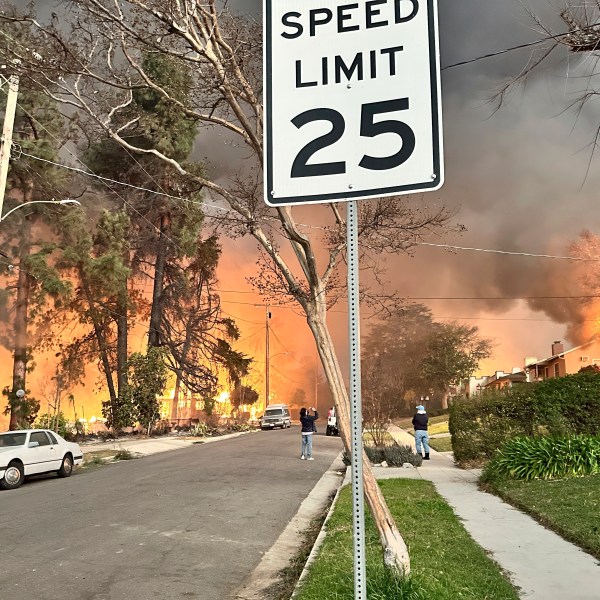 The Eaton Fire burns homes as Ryan Pearson, a Los Angeles-based entertainment video editor for The Associated Press, drives through his neighborhood in Altadena, Calif., Wednesday, Jan. 8, 2025. (AP Photo/Ryan Pearson)