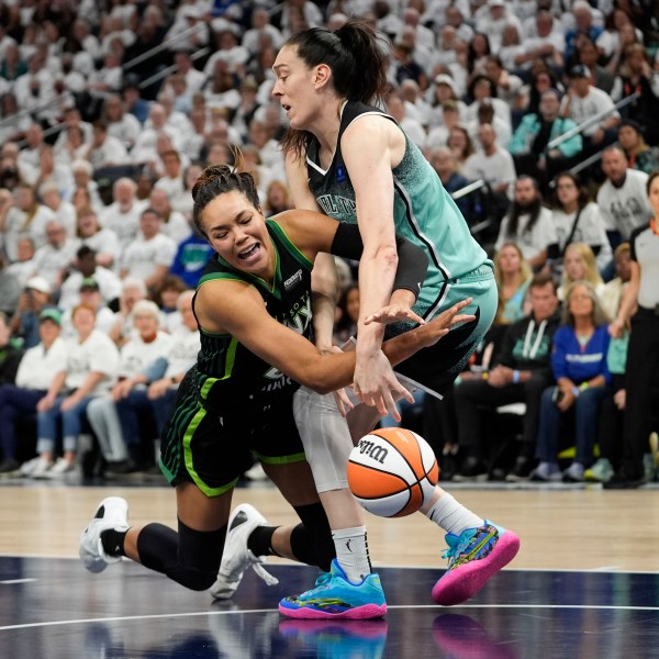 FILE -Minnesota Lynx forward Napheesa Collier and New York Liberty forward Breanna Stewart, right, battle for a loose ball during the second half of Game 4 of a WNBA basketball final playoff series, Oct. 18, 2024, in Minneapolis. (AP Photo/Abbie Parr, File)