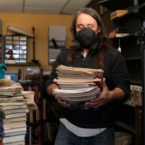 Steve Alejandro works in his office near the room where his wife, Ashley, spends most of her time due to illness in the basement of their home Wednesday, Dec. 18, 2024, in Wentzville, Mo. (AP Photo/Jeff Roberson)