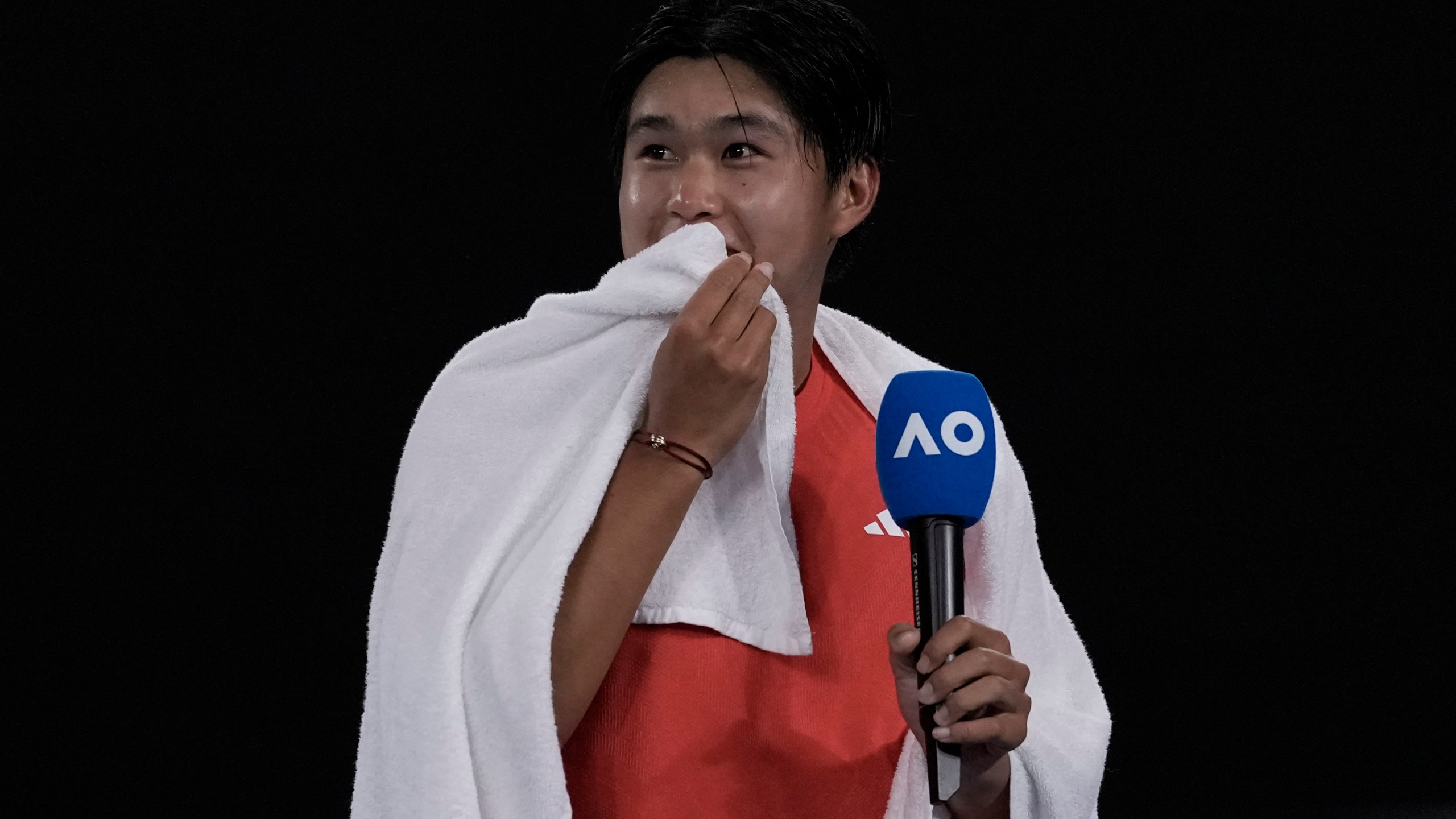 Learner Tien of the U.S. speaks after winning his second round match against Daniil Medvedev of Russia at the Australian Open tennis championship in Melbourne, Australia, in the early hours of Friday, Jan. 17, 2025. (AP Photo/Ng Han Guan)