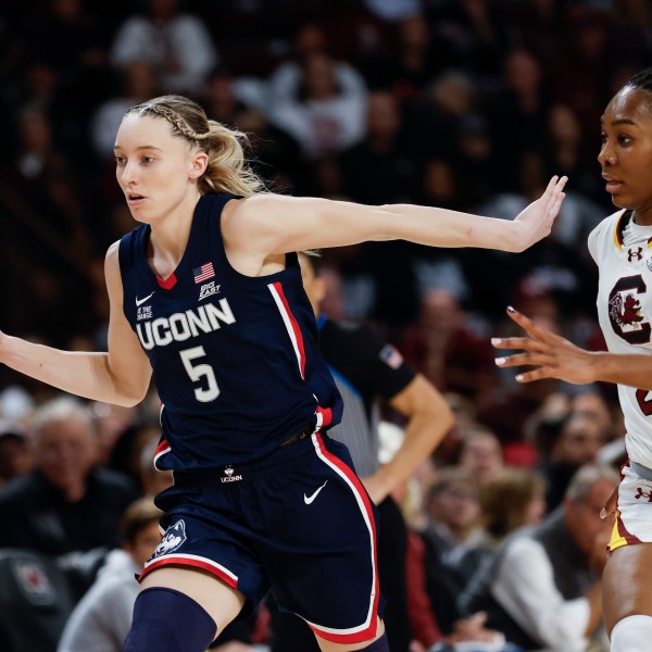 UConn guard Paige Bueckers (5) pushes the ball upcourt past South Carolina guard Bree Hall during the second half of an NCAA college basketball game in Columbia, S.C., Sunday, Feb. 16, 2025. (AP Photo/Nell Redmond)