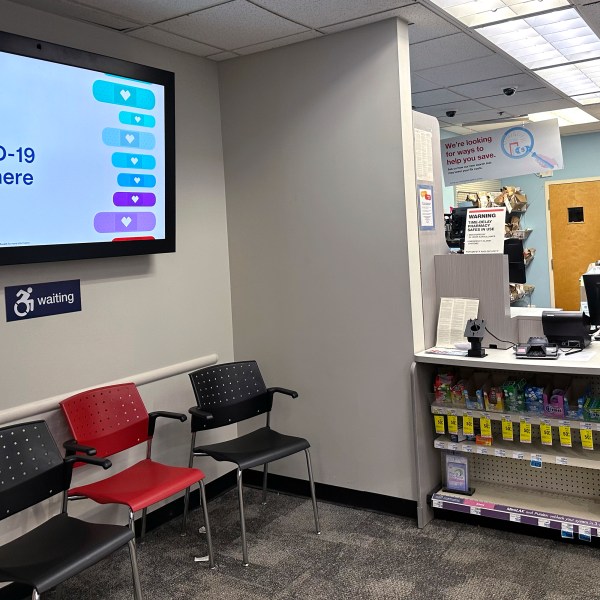 A sign for flu vaccination is displayed on a screen at a pharmacy store in Buffalo Grove, Ill., Tuesday, Feb. 13, 2024. (AP Photo/Nam Y. Huh, File)