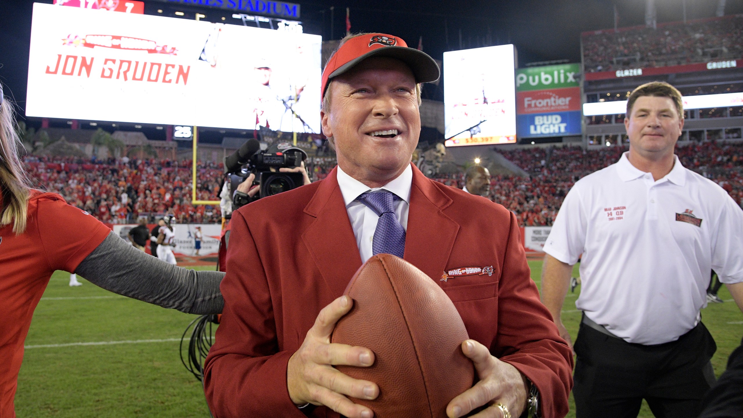 FILE - Former Tampa Bay Buccaneers head coach Jon Gruden, center, reacts after being inducted into the Buccaneers Ring of Honor during halftime of an NFL football game against the Atlanta Falcons Monday, Dec. 18, 2017, in Tampa, Fla. (AP Photo/Phelan M. Ebenhack,File)