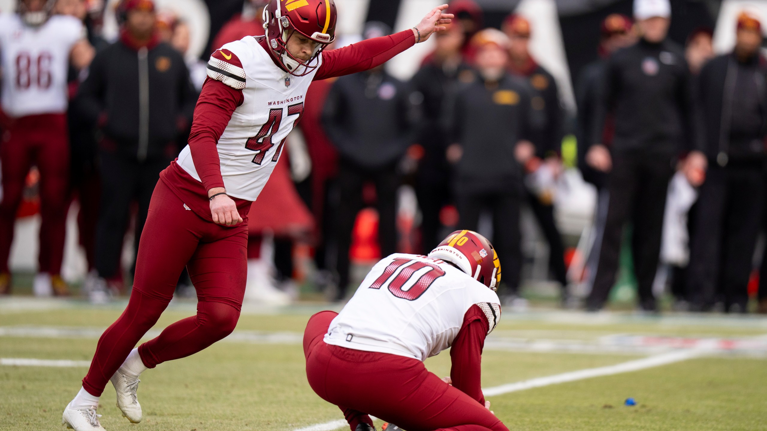 Washington Commanders kicker Zane Gonzalez (47) kicks the field goal with punter Tress Way (10) holding during the NFL championship playoff football game against the Philadelphia Eagles, Sunday, Jan. 26, 2025, in Philadelphia. (AP Photo/Chris Szagola)