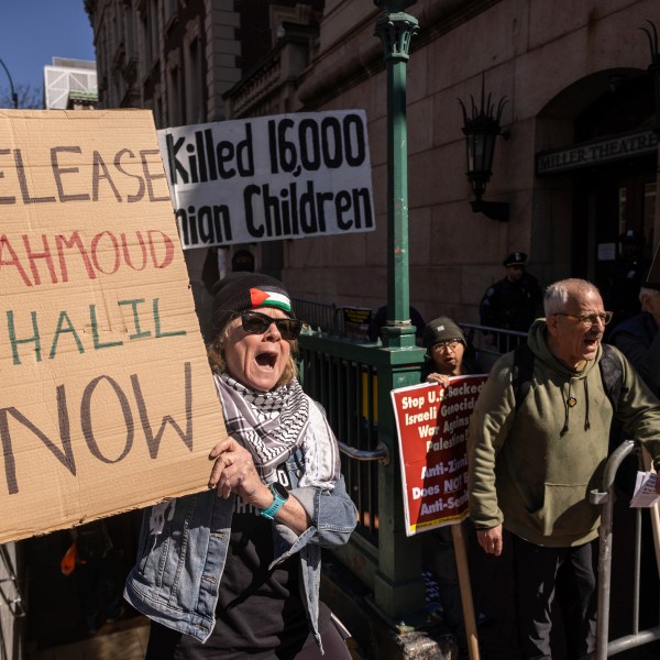 A protester raises signs during a demonstration in support of Palestinian activist Mahmoud Khalil outside Columbia University, Monday, March 10, 2025, in New York. (AP Photo/Yuki Iwamura)