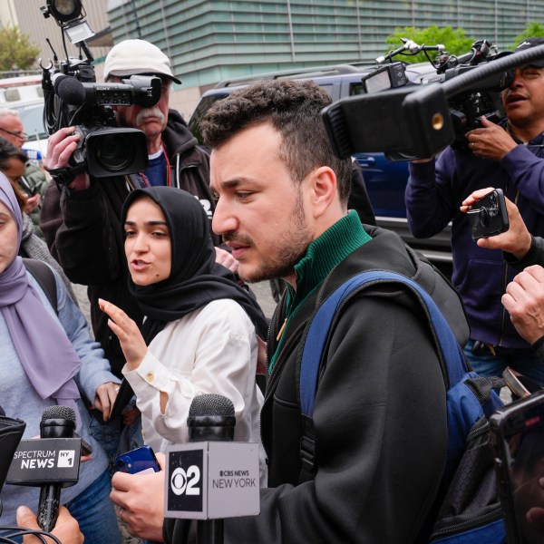 FILE - Members of the Columbia University Apartheid Divest group, including Sueda Polat, second from left, and Mahmoud Khalil, center, are surrounded by members of the media outside the Columbia University campus, Tuesday, April 30, 2024, in New York. (AP Photo/Mary Altaffer, File)